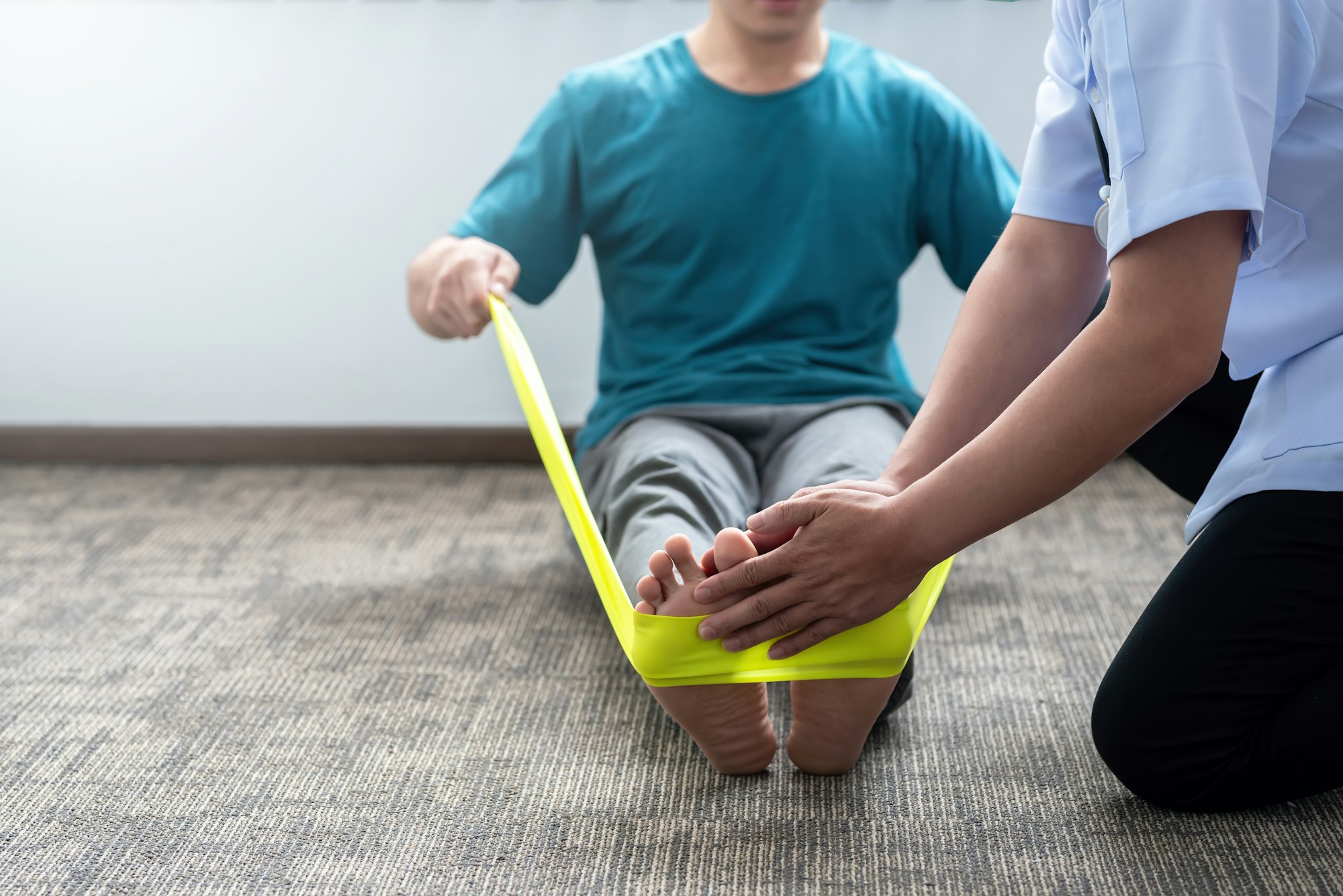 Physical therapy on feet - Close-up of a man practicing physical therapy at a clinic.