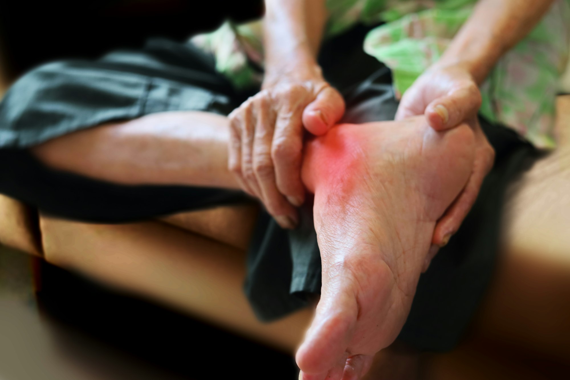 Elderly man holding his ankle, ankle pain. Arthritis