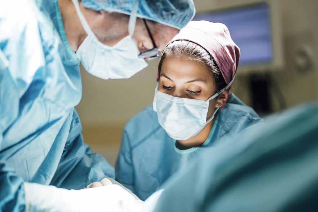 Reconstructive Surgery - Surgeons and nurse during a foot surgery